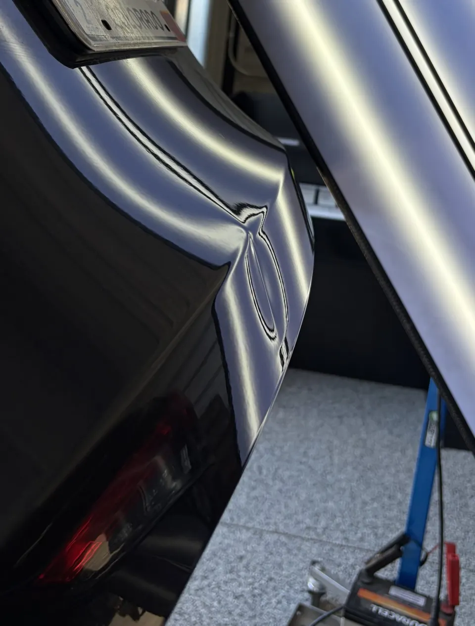 Rear bumper dent before repair
