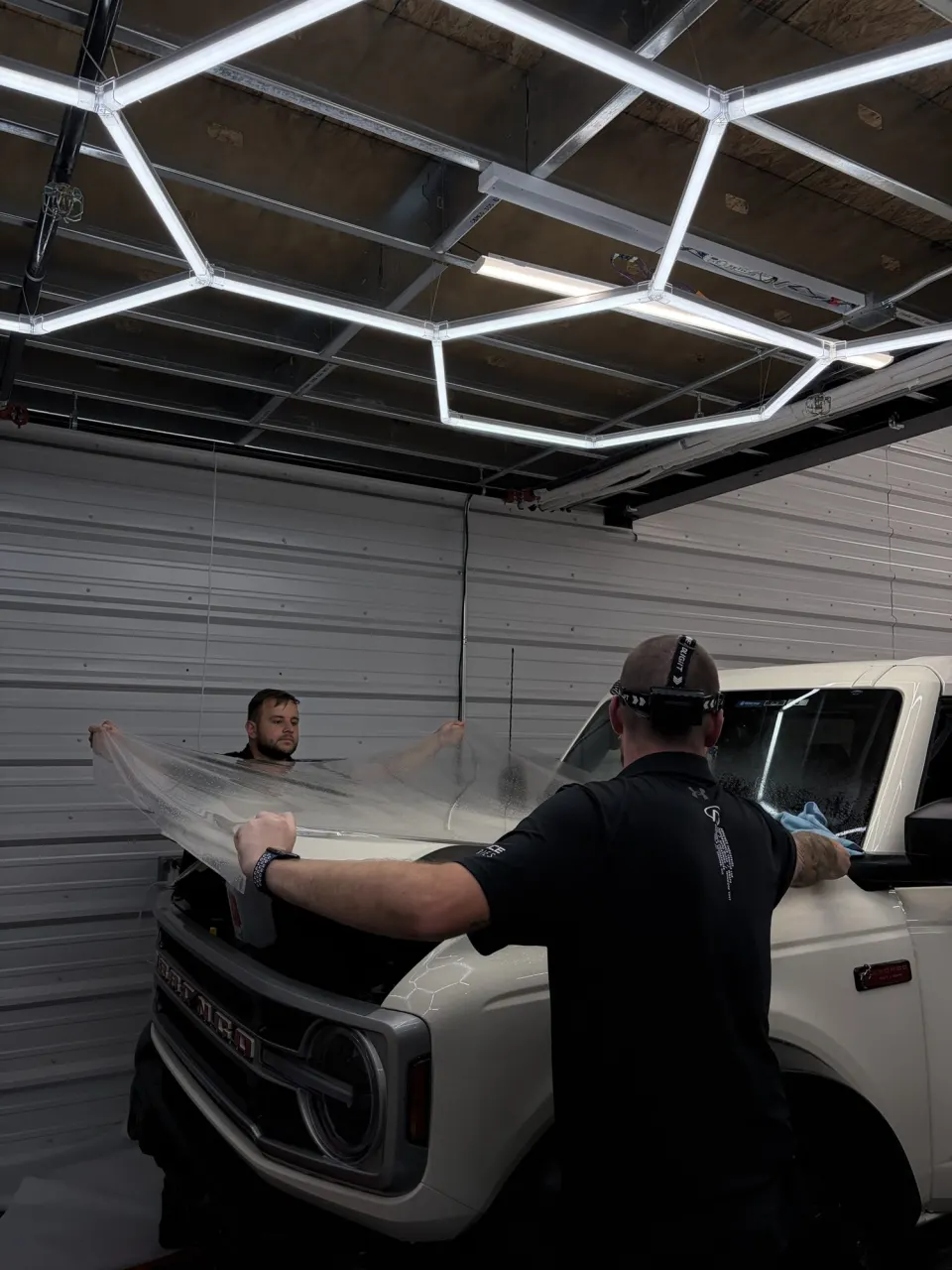 Paint protection film being installed at Mirror Works